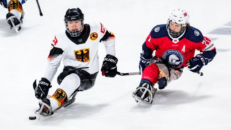 Two male Para ice hockey players from Germany and Norway on ice