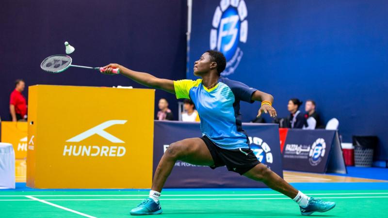 A female badminton athlete in action.