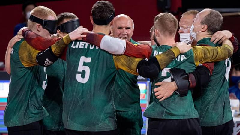 A group of Lithuanian goalball players with their arms around each other