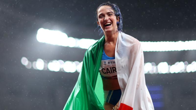 Para sprinter Martina Caironi laughing with the Italian flag wrapped round her