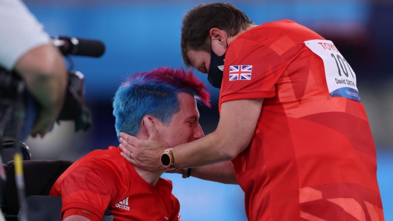 Boccia player David Smith is hugged by his coach in celebration 