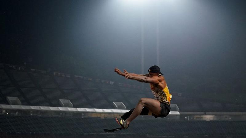 A man with a prosthetic leg in a long jump competition