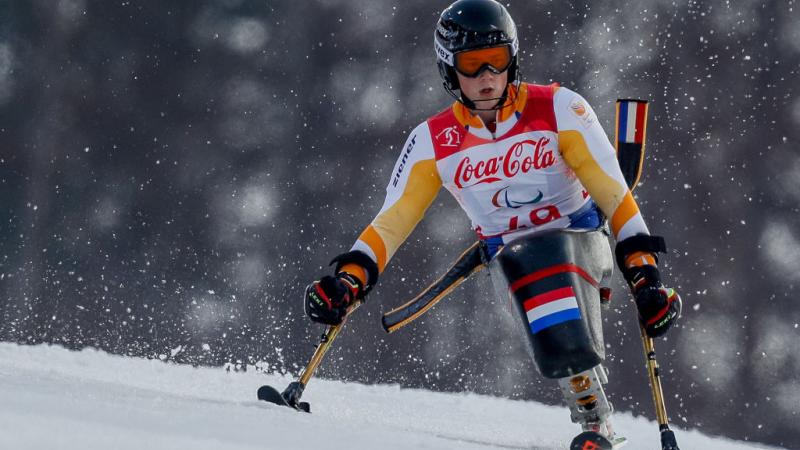 A male Para alpine sit-skier in competition.