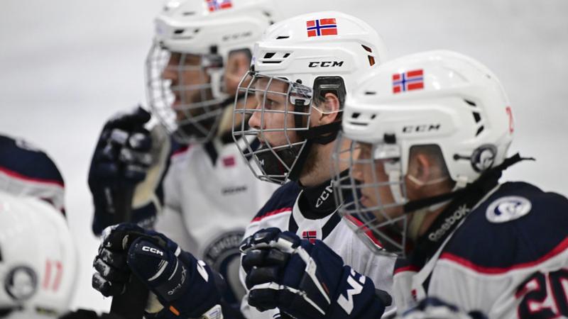 Three male Para ice hockey players looking straight