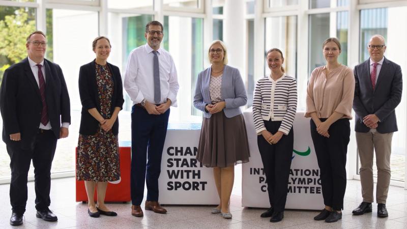 Seven people, including State Minister for Sport and Volunteering, pose for a photograph at the IPC Campus