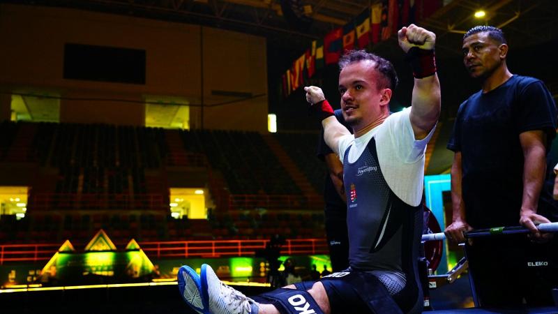 An athlete reacts after a successful lift