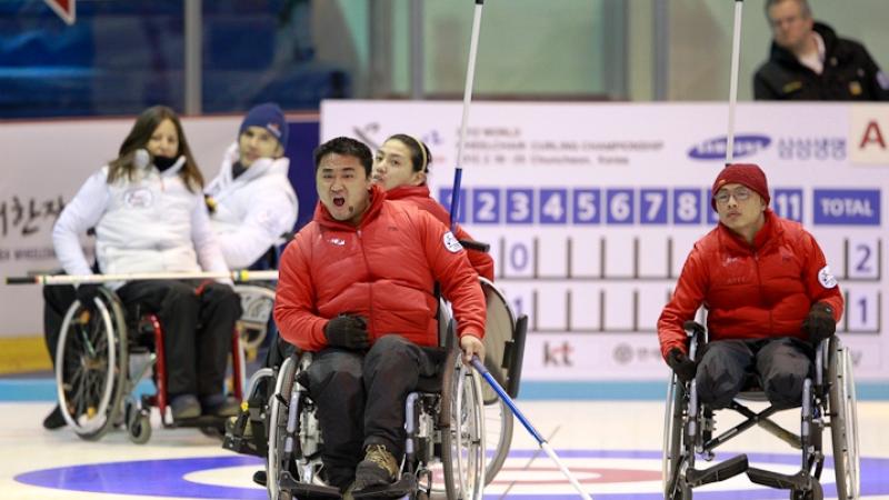 An athlete from the Korean Wheelchair Curling Team celebrates a point on Day 4 of the 2012 World Wheelchair Curling Championships