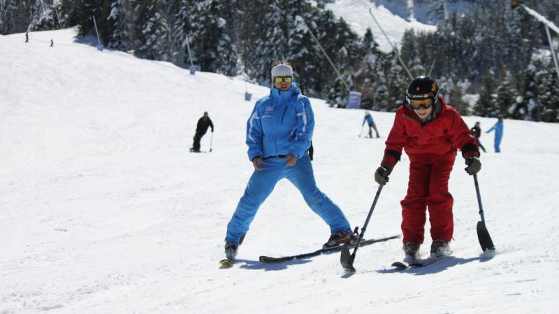 boy skiing with coach