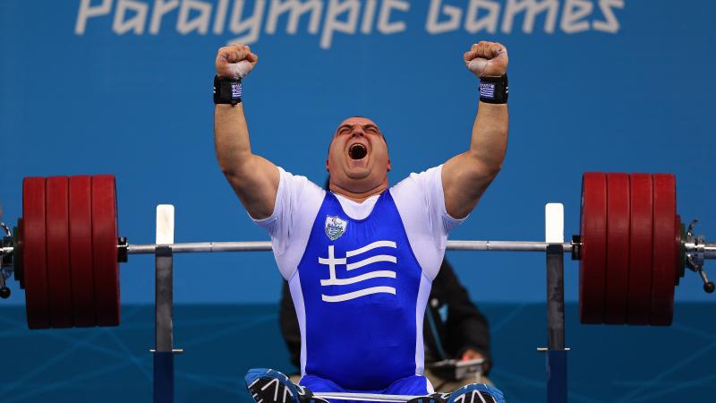 Pavlos Mamalos of Greece reacts with intense joy as he competes in the Men's -90 kg Powerlifting event.