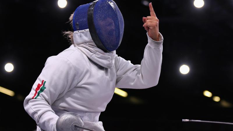A picture of a Wheelchair Fencer celebrating her victory 