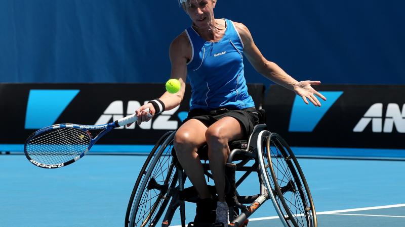 Germany's Sabine Ellerbrock sits in her wheelchair and hits a tennis ball.