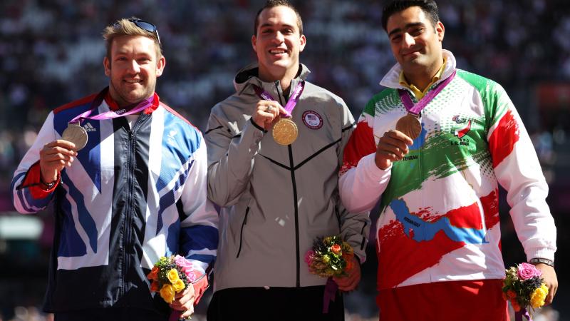Dan Greaves, Jeremy Campbell and Farzad Sepahvand pose on the podium during the medal ceremony for the Men's Discus Throw F44 final at the London 2012 Paralympic Games