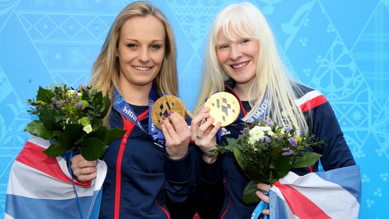 Great Britain's Kelly Gallagher (right) and guide Charlotte Evans (left) celebrate winning Sochi 2014 gold in the women's Super-G