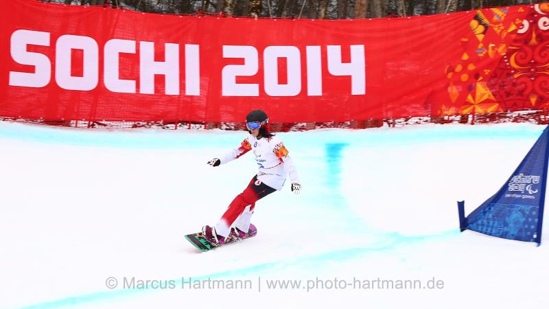 Michelle Salt, Canada flys by a gate in the first ever Women's Para Snowboarding Cross in the Winter Paralympic Games