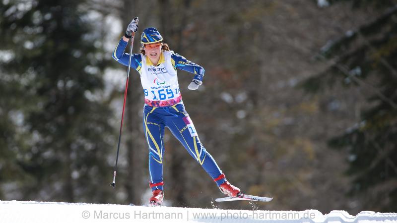 Women on cross country ski in action on the track