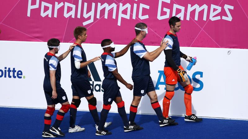 Team Great Britain marching onto the field led by their goalkeeper in the Football 5-a-side during the London 2012 Paralympic Games.