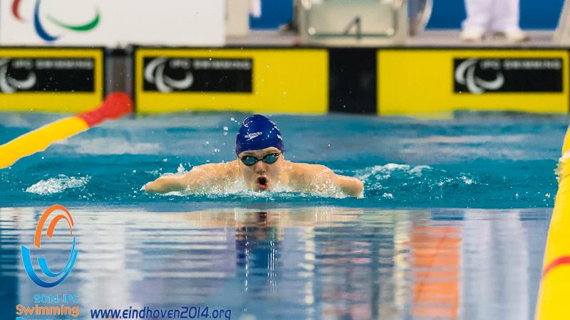 A swimmers emerges from the water to begin a stroke