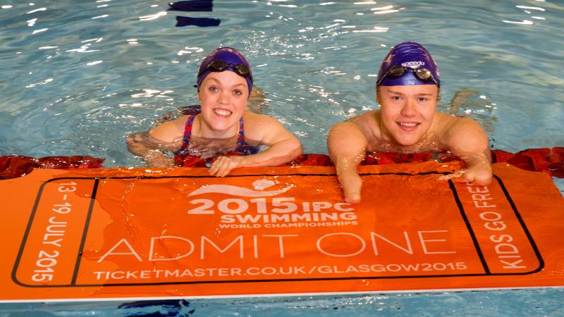 Ellie Simmonds and Andrew Mullen in the pool with a huge ticket in hand