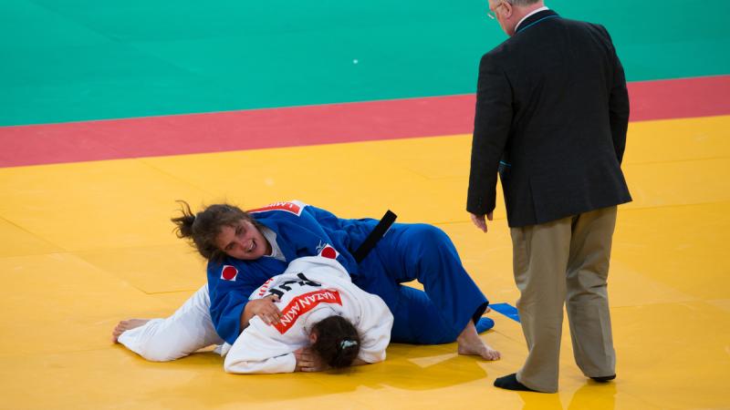 Two women on the floor, practising judo