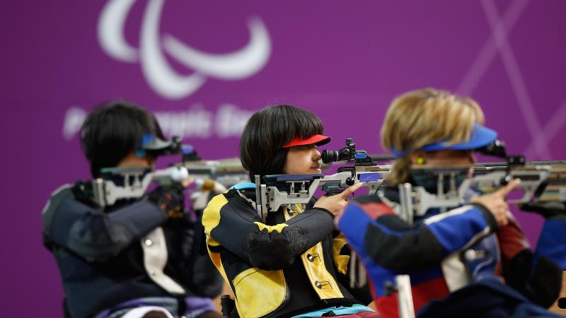 Yoojeong Lee of the Republic of Korea (R) shoots during the Women's R8-50m Rifle 3 Positions-SH1 final at the London 2012 Paralympic Games