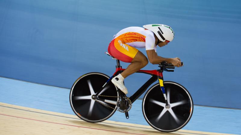 Cyclist with one leg in action on the track
