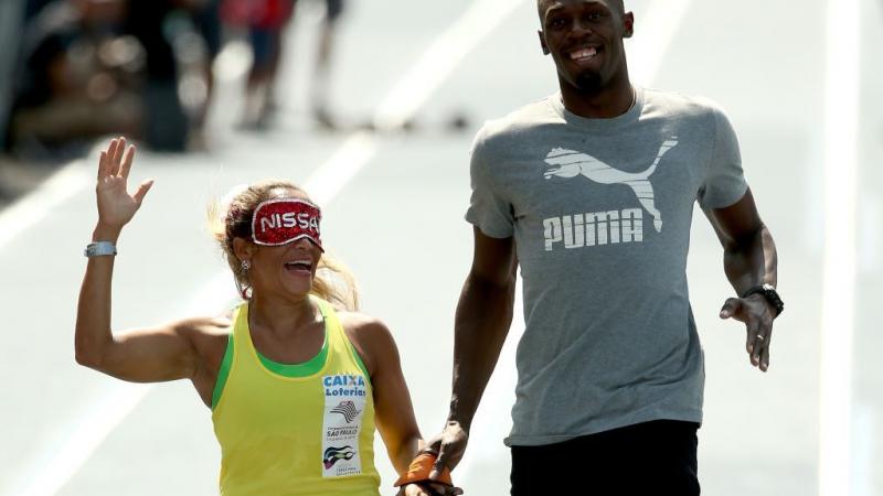 Paralympian Terezinha Guilhermina of Brazil runs with Usain Bolt of Jamaica as her guide during an exhibition in preparation for the Mano a Mano Athletics Challenge in Rio de Janeiro, Brazil. In 2011, she was elected to the APC Executive Committee at the Guadalajara Parapan American Games.