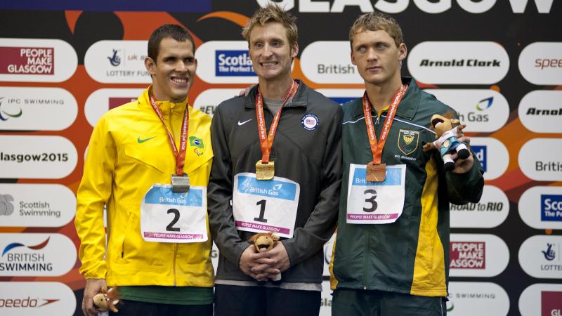 Bradley Snyder, Matheus Sousa and Hendri Herbst on the podium after the Men's 100m Freestyle S11 at the 2015 IPC Swimming World Championships in Glasgow.