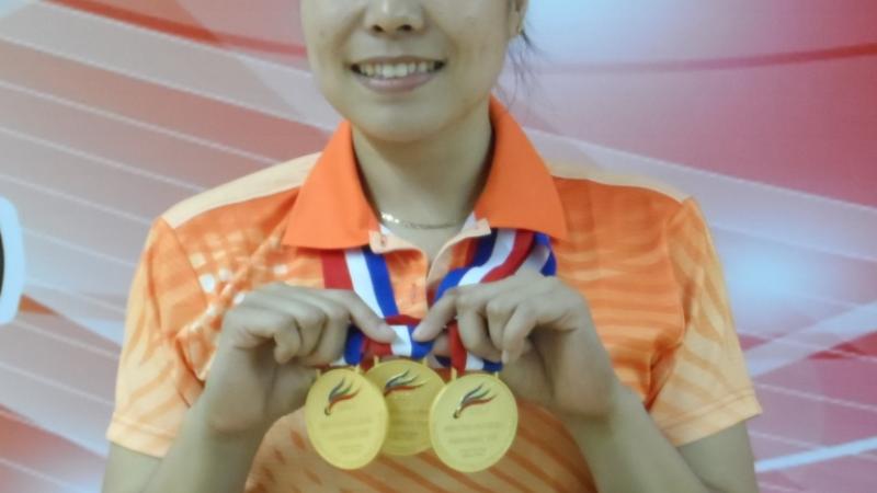 Woman holding medals