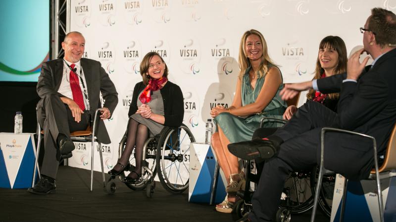 Three women and two men sitting on the podium during a podium discussion at Vista 2015.