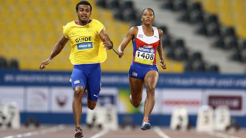 Woman and man sprinting on a track side by side
