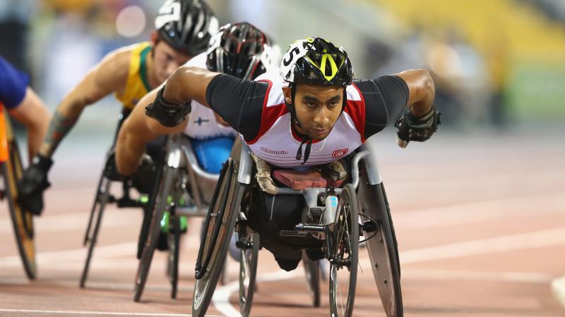 Man leading a pack in a wheelchair race