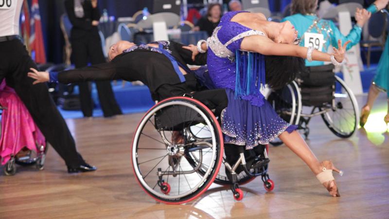 Man in wheelchair and woman performe.