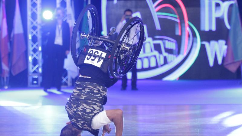 Man in wheelchair does headstand