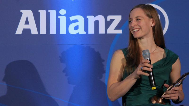 Anna Schaffelhuber with her awards trophy, smiling