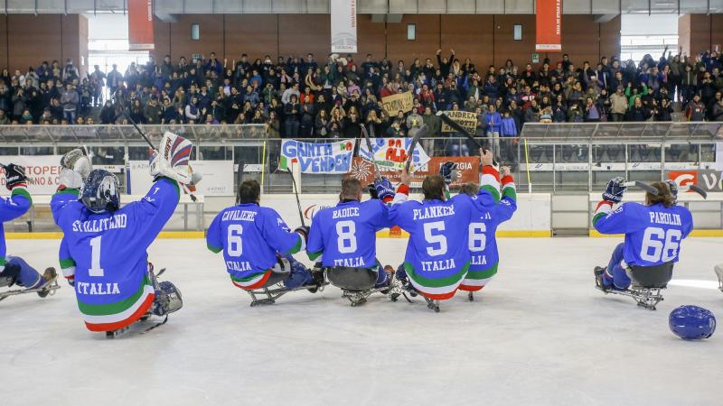 Italian ice sledge hockey players thank their supporters after making it to the final of the international tournament in 2015