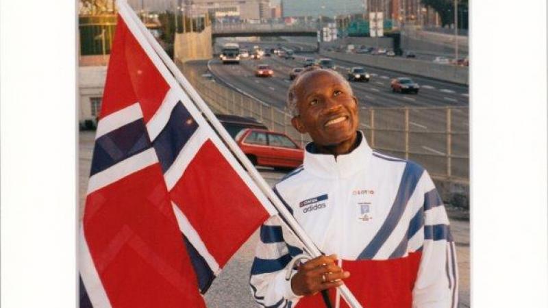 Athlete holding the Norwegian flag. 