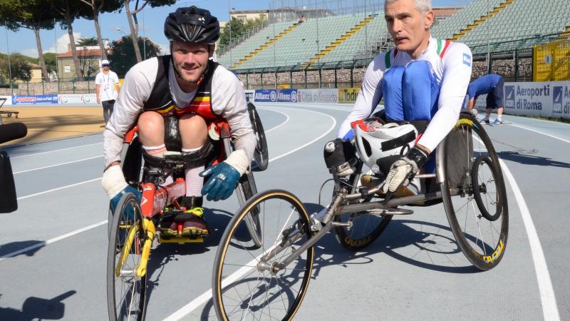 Two wheelchair racers on the track after their race