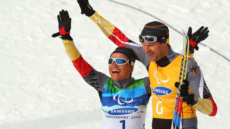 Verena Bentele and her guide Thomas Friedrich of Germany celebrate winning the Women's 3km Pursuit Visually Impaired Biathlon at the 2010 Vancouver Winter Paralympics.