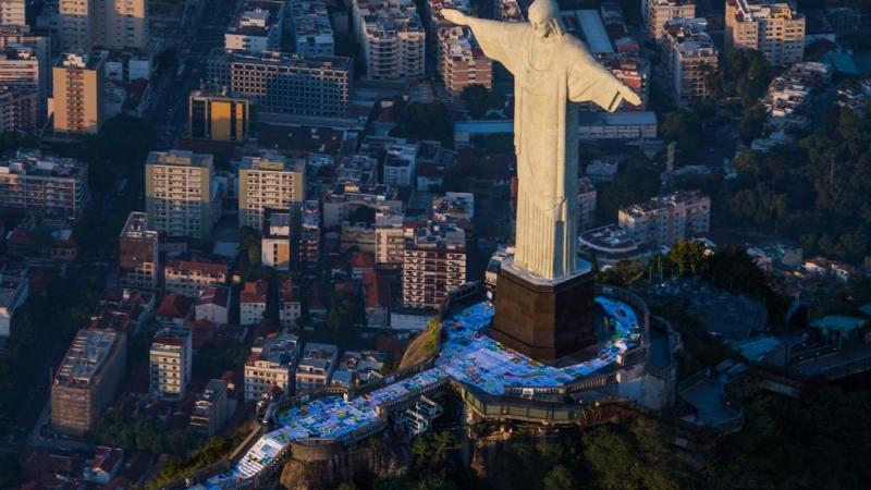 The giant flag was divided into seven pieces to be transported up to the Christ statue 