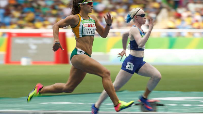 Ilse Hayes RSA and Kym Crosby USA compete in the Heat 2 of the Women's 100m - T13 at the Olympic Stadium.