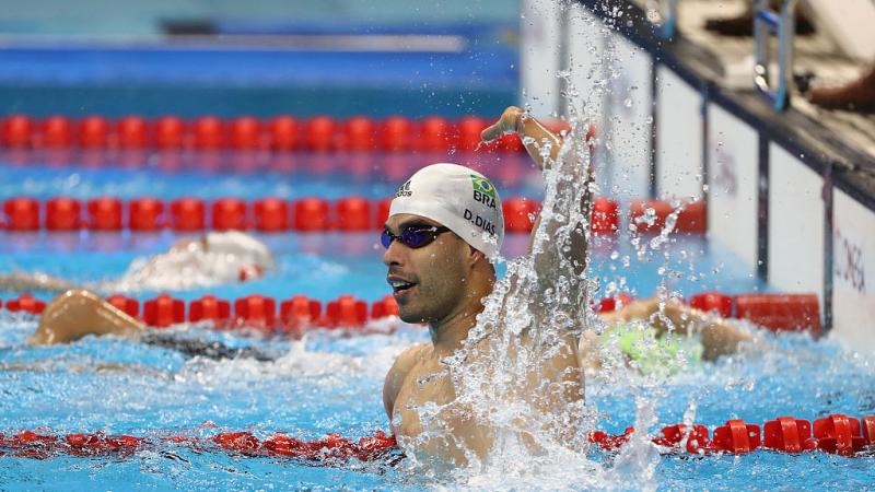 A swimmer celebrates winning gold