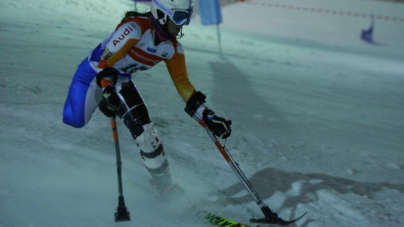 Woman with one leg skiing down a slope