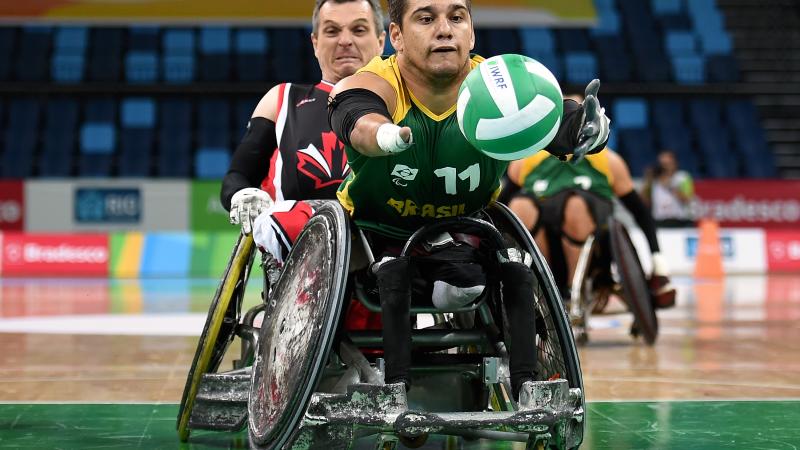 A wheelchair rugby player chasing for the ball