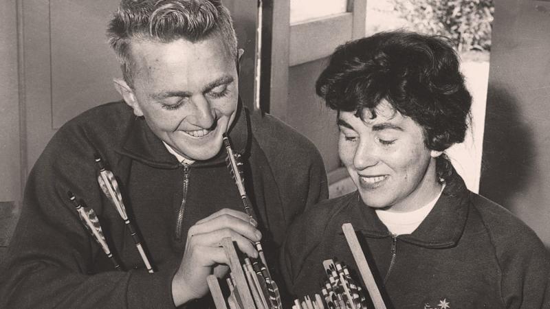 A smiling couple on a black and white picture