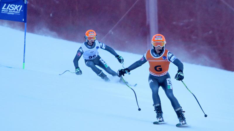 A visually impaired skier takes a bend