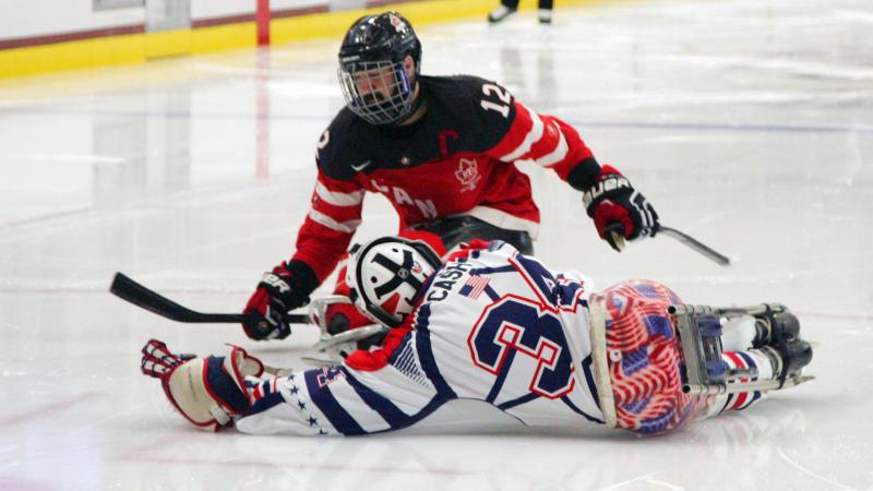 Steve Cash making a save against Greg Westlake in the gold medal game USA v Canada at the 2015 IPC Ice Sledge Hockey World Championships A-Pool in Buffalo, USA.