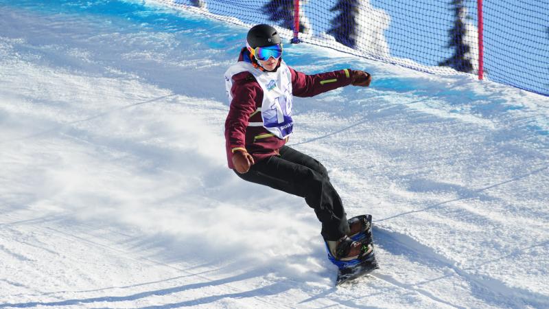 Woman on snowboard turns on a banked turn