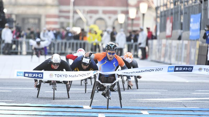 Japan's Sho Watanabe crosses the line to take the 2017 Tokyo marathon ahead of Switzerland's Marcel Hug.