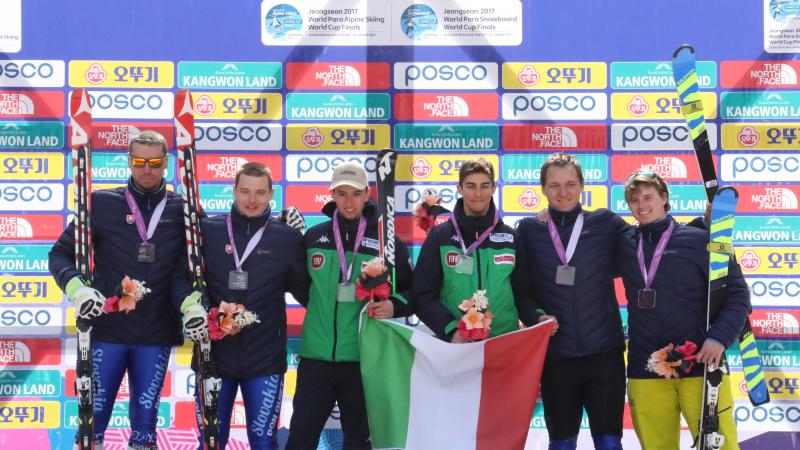 Six skiers on a podium