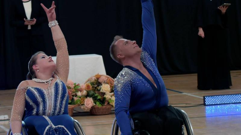 Man and woman in wheelchairs dance